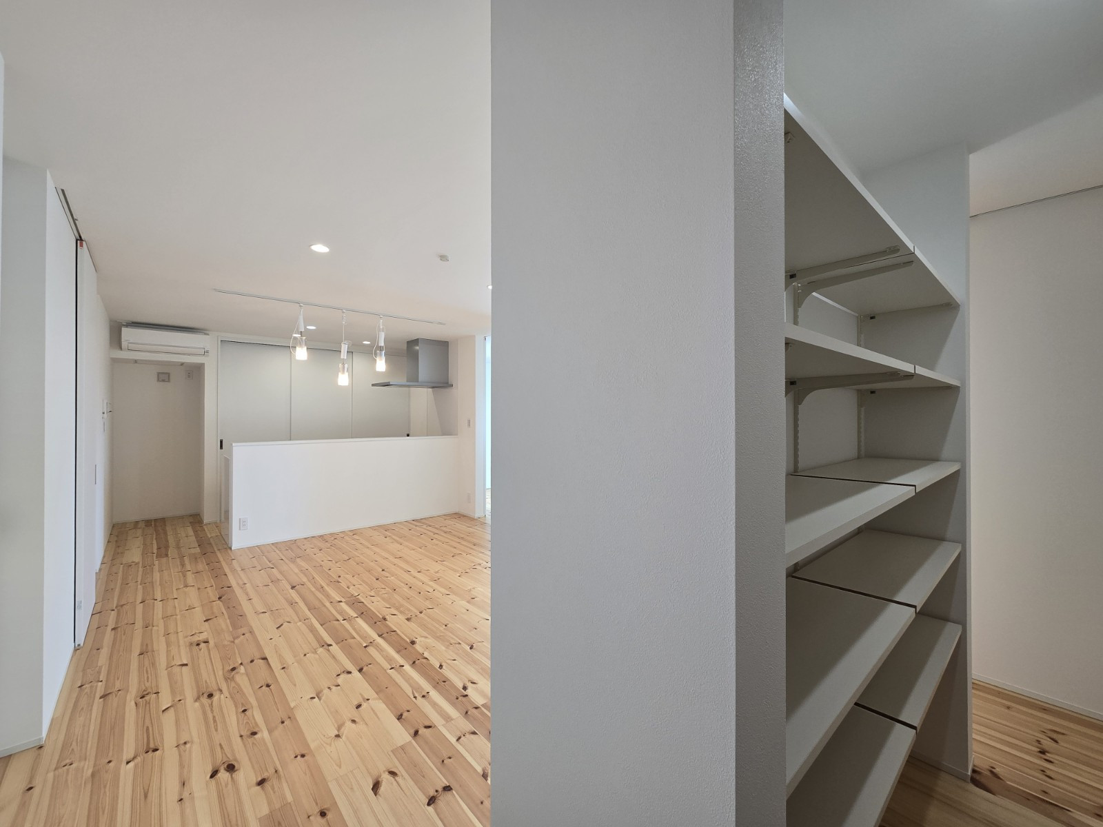 廊下やリビングに隣接する、可動棚付きの収納。壁面はテレビスペースとして使用し、裏面には収納を設けているのでリビング周りを常にスッキリと保てます。